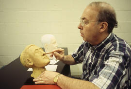 Photograph of a Funeral Services student practicing learned techniques on a mannequin