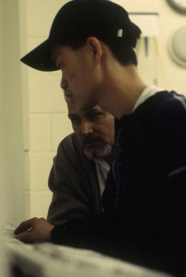 Photograph of a students operating a mouse in the computer lab