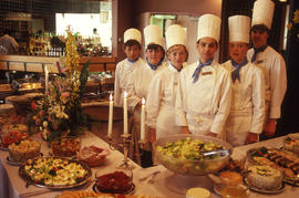 Photograph of student chefs at a food table