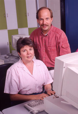 Photograph of two staff members at a computer
