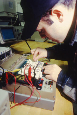Photograph of a student in the Electronics program at work