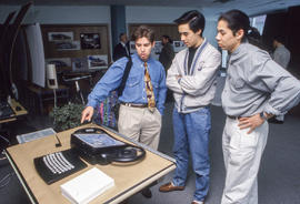 Photograph of three students at the Industrial Design fair