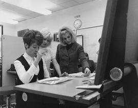 Photograph of an Interior Design Instructor Assisting Students in her Office