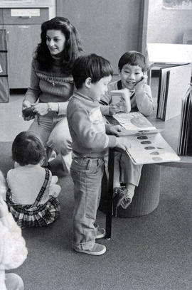 Photograph of a Daycare Centre Staff Member Speaking With Some of the Children