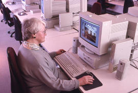 Photograph of a woman working at a computer