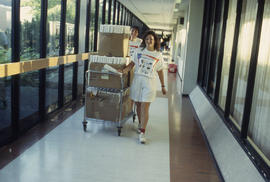 Photograph of Orientation Volunteers Wheeling Materials