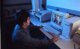 Photograph of a staff member editing a photograph at a computer