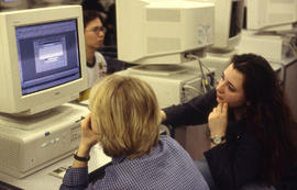 A photograph of two students working together at a computer