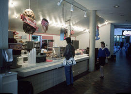 Photograph of a student making a purchase at the Swirls Frozen Yogurt & Ice Cream counter