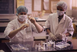 Photograph of a Pharmacy Assistant Student Preparing a Syringe