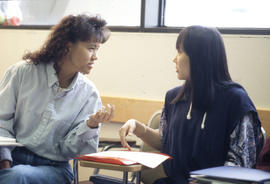 Photograph of Two Students Talking in Class