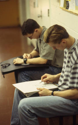A photograph of Industrial Design students completing sketches