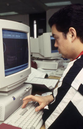 A photograph of a student working with software on a computer