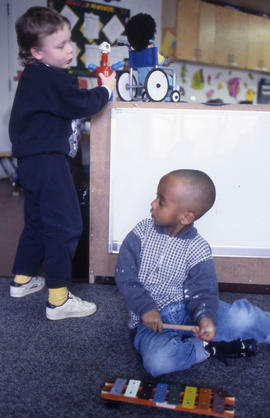 Photograph of two young children playing with toys