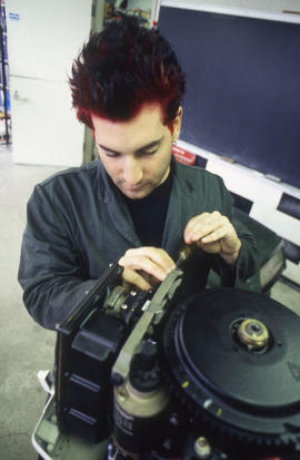 Photograph of a student working on a small engine