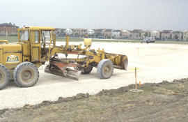 Photograph of a front end loader working on a marl surface