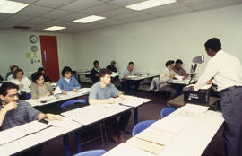 A photograph of a professor instructing their class