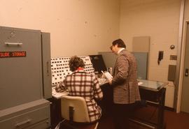 Two staff members working with photo slides : [photograph]