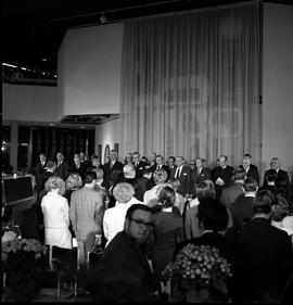 Photograph of guests standing for the national anthem at the official opening of the Phase II bui...