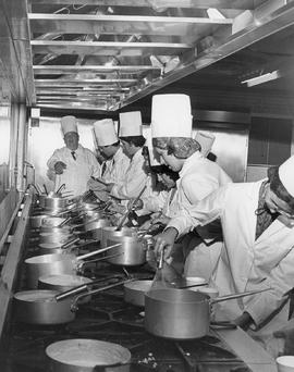 Photograph of Igor Sukor Directing a Team of Culinary Students