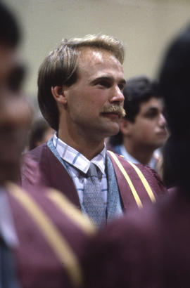 Photograph of a Graduate sitting in the Convocation audience
