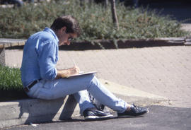 Photograph of a student studying and writing notes