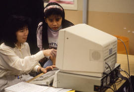Photograph of two students working at a computer together