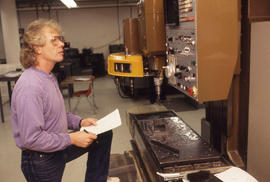Photograph of a Person Checking a Display on a Machine