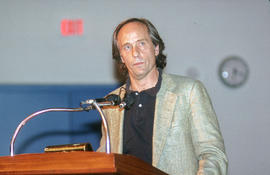 Photograph of Richard Ford standing at the podium