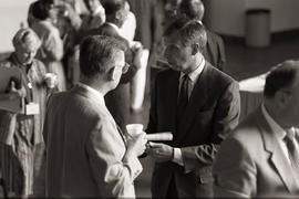 Photograph of Humber President Dr. Robert A. Gordon speaking with a showcase attendee