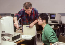 Photograph of a professor working with a student at a computer