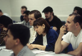 Photograph of students listening intently in a COBOL programming class