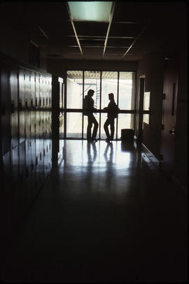 Photograph of students in a dark hallway