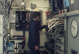 Photograph of a Technician working on a video distribution console