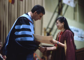 Photograph of a person at the Graduation ceremony signing for the deaf