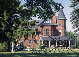 Photograph of children on the swing set adjacent to Cumberland House