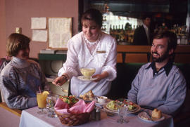 Photograph of Hotel and Restaurant student serving customers in the Humber Room