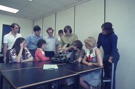 Students and IMC staff with photoslide carousel, tape recorder and reel-to-reel machine : [photog...