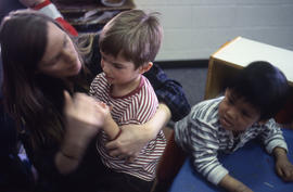 Photograph of a daycare centre worker working with toddlers