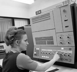 Photograph of Judy Clark using an IBM machine