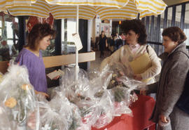 Photograph of a student selling flowers from a cart