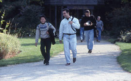 Photograph of People Walking Down a Pathway