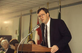 Photograph of Daimler-Chrysler executive standing at the podium