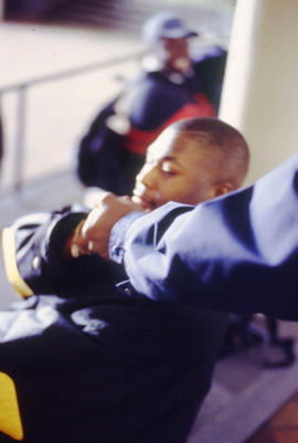 Photograph of students sitting by the ramp in the concourse