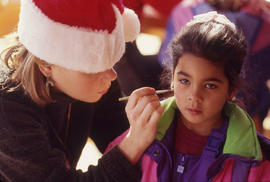 Photograph of Someone Painting a Kid's Face