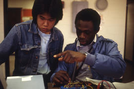 Photograph of Electronics students working with a circuit plug board