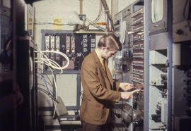 Photograph of an IMC Technician working with a video distribution console