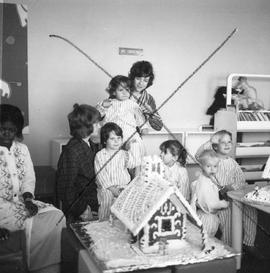 Photograph of Children in the Pediatric Ward Admiring a Gingerbread House