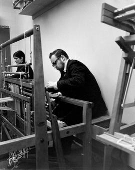 Photograph of a Student Using a Loom in his Weaving Class