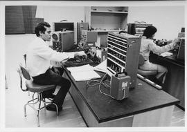 Photograph of Electronic Students using an Oscilloscope During Testing